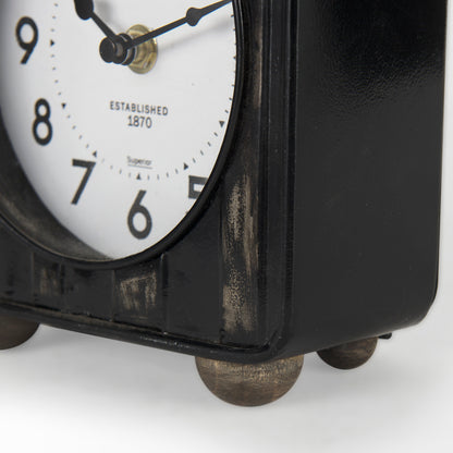 Karl 6.0L x 3.0W x 6.8H Rustic Black Iron Rounded Square Table Clock